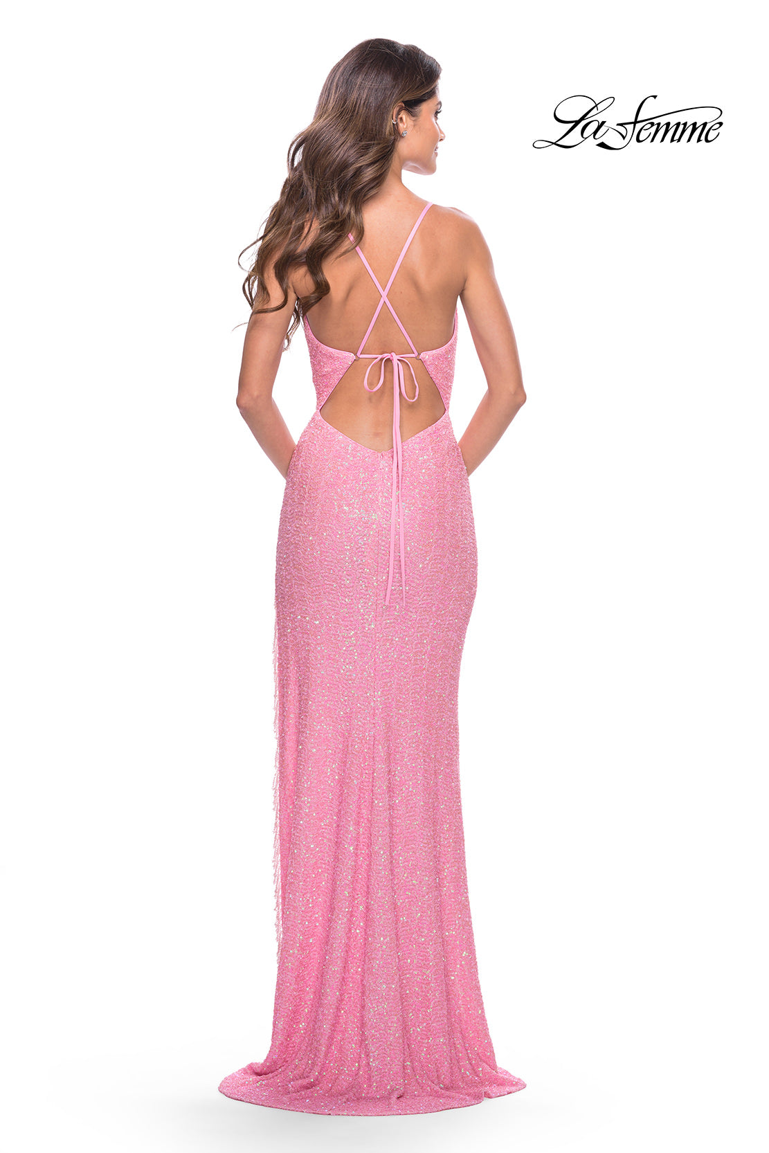 A woman faces away, wearing the La Femme Open-Back Pastel Sequin Prom Dress 31444 with crisscross straps. The
